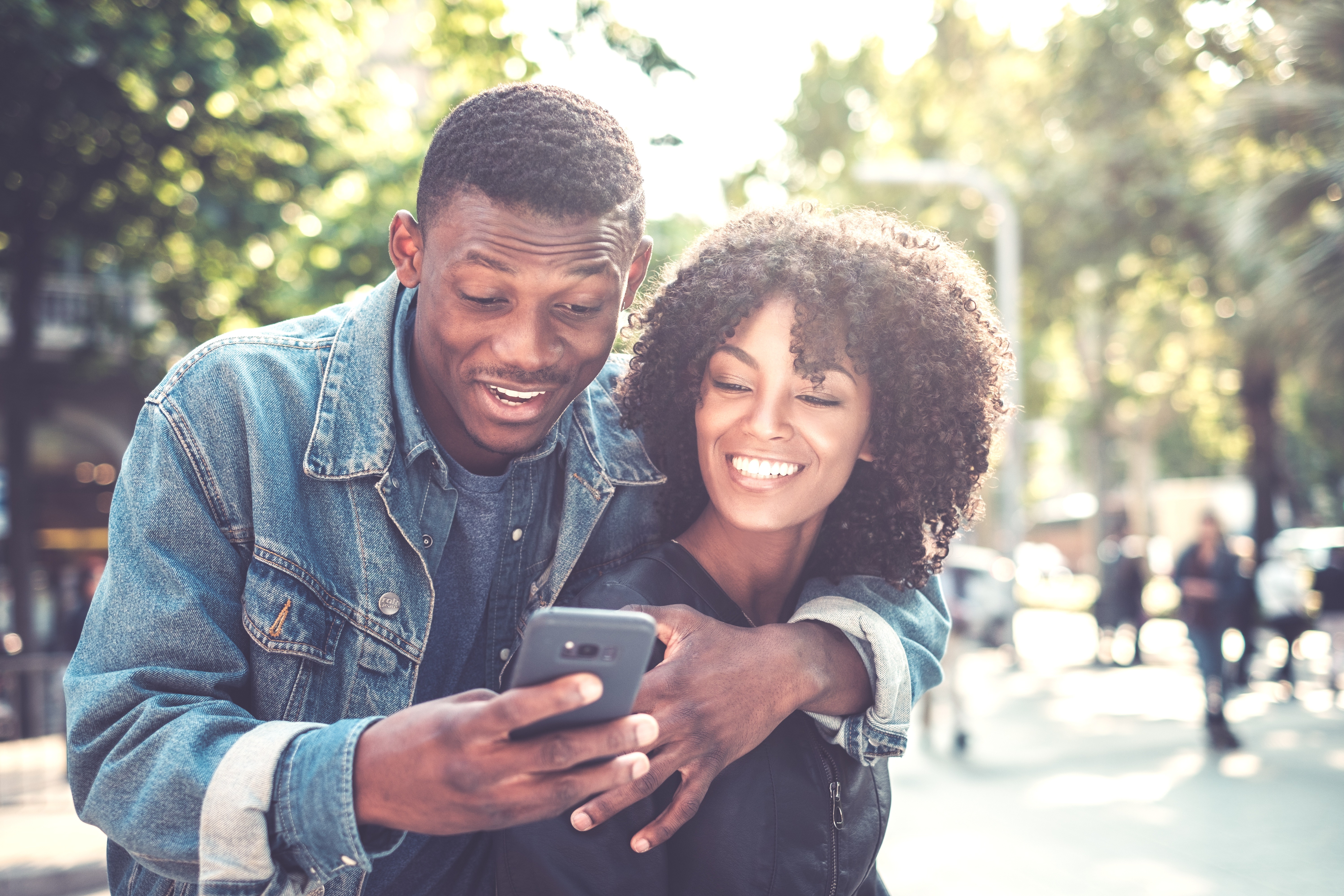 happy black couple on phone